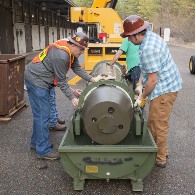 Employees for Engineering Research and Consulting, Inc., a defense contractor working at Anniston Munitions Center with the Redstone Test Center, remove a Lance missile from its case as they prepare for demilitarization through de-tanking of the...